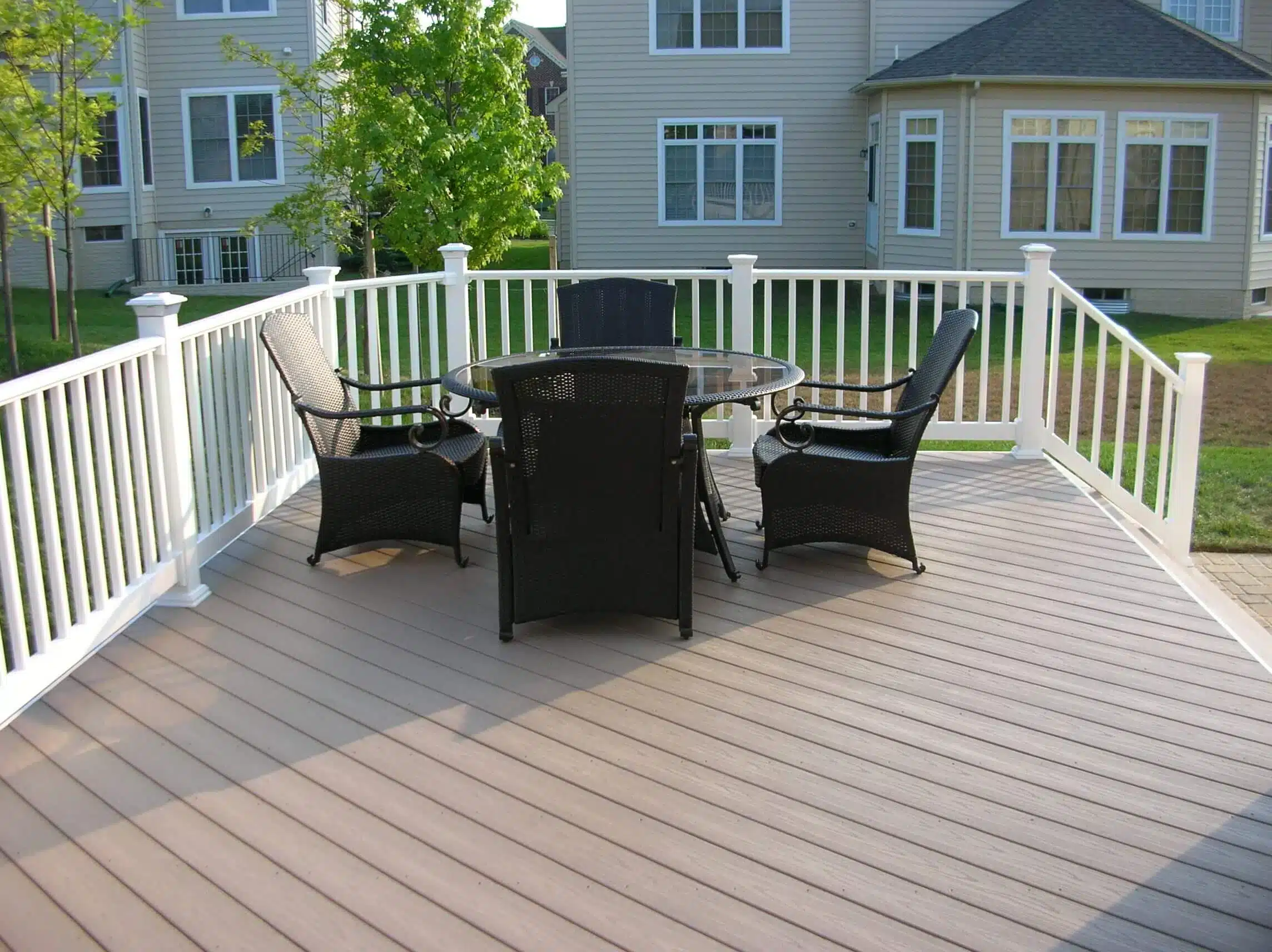 photo of a composite deck with outdoor furniture and deck railing