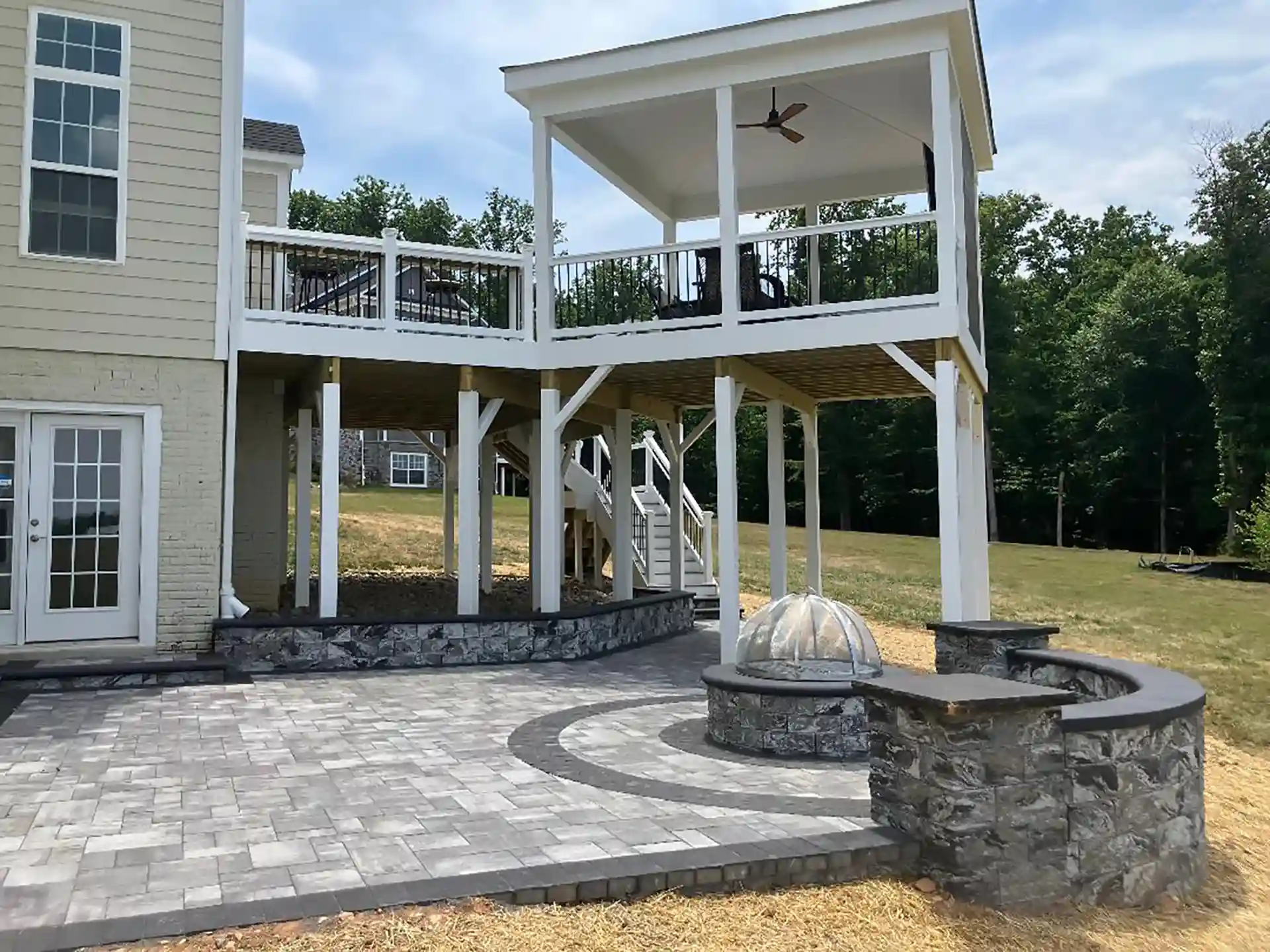 PHoto of an elevated deck with a patio and fire pit
