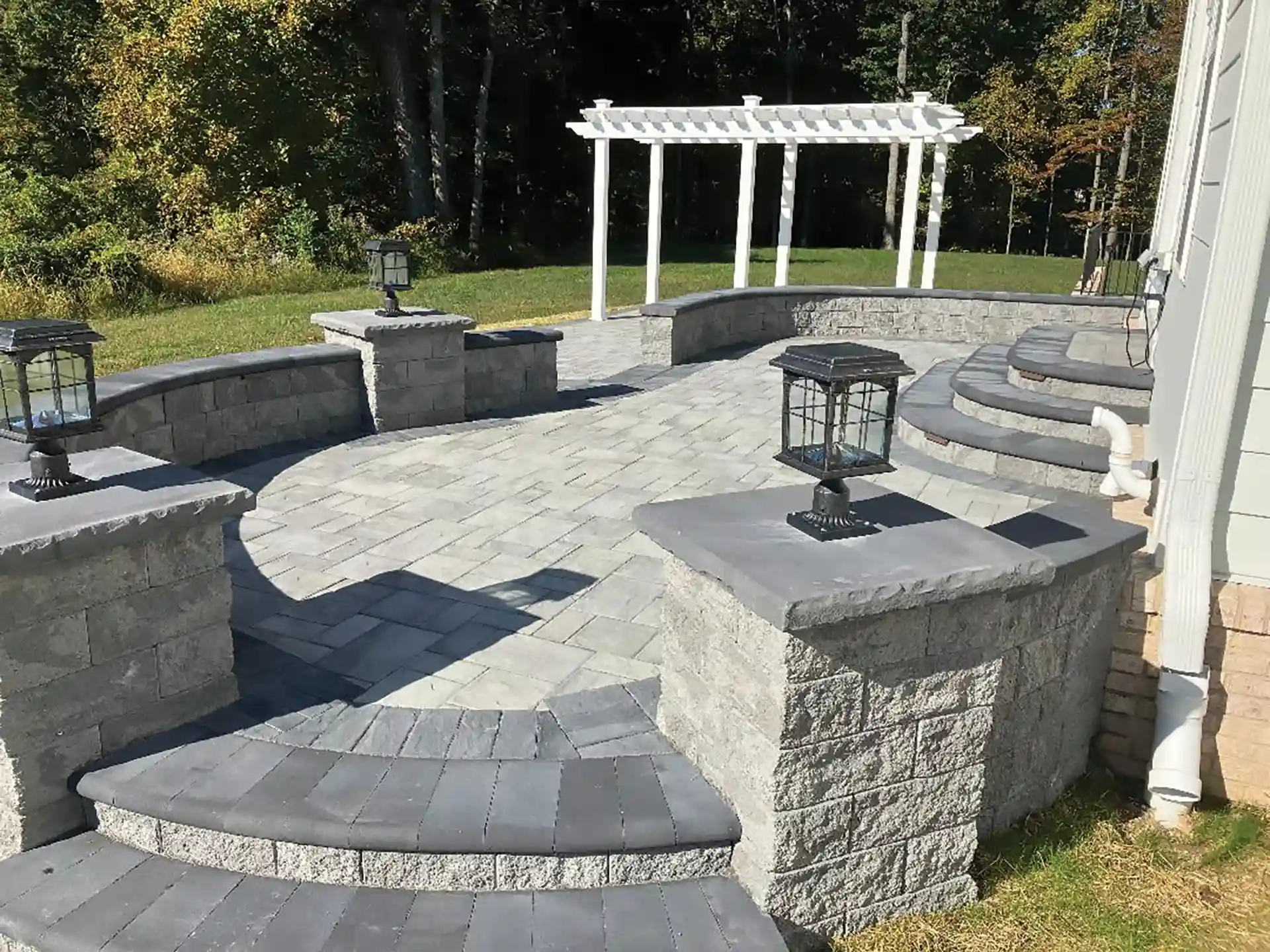 Photo of a traditional pergola in white with a custom patio
