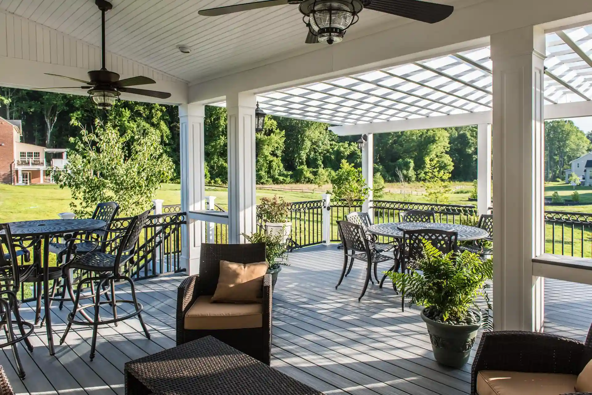 Photo of a covered deck that is covered partially by a solid roof and partially by a traditional pergola
